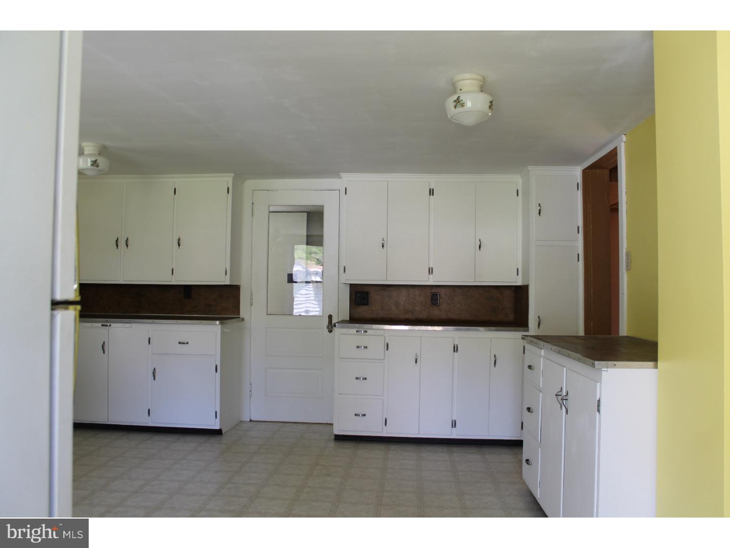 1724 Ramich Road Temple, PA 19560 - Photo 8 of 25 a kitchen with cabinets appliances and a wooden cabinets