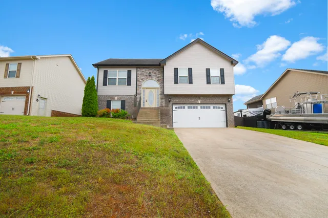 a front view of a house with a yard and garage
