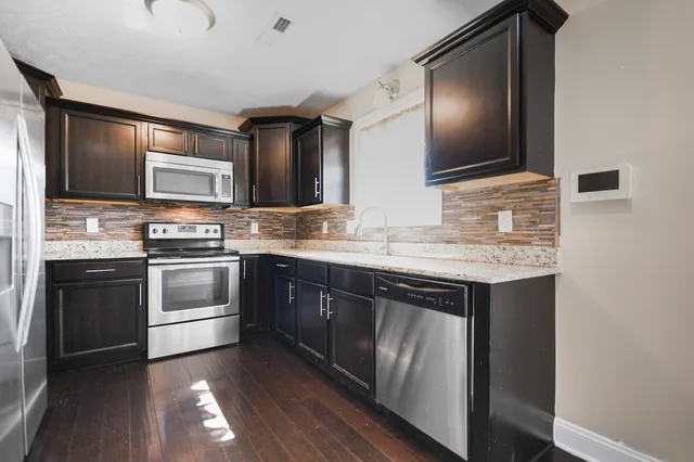 a kitchen with a sink stove and microwave