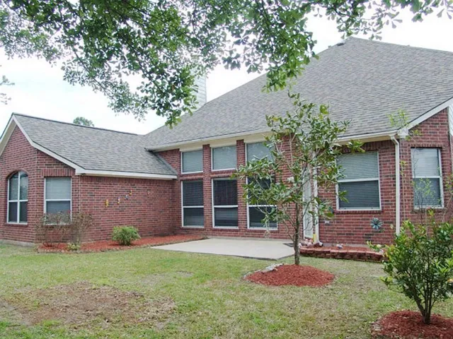 a house that has a tree in front of the house
