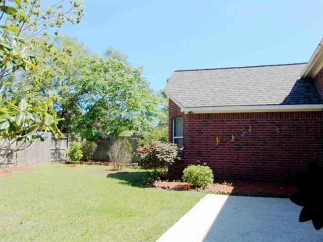 a view of brick wall and potted plants