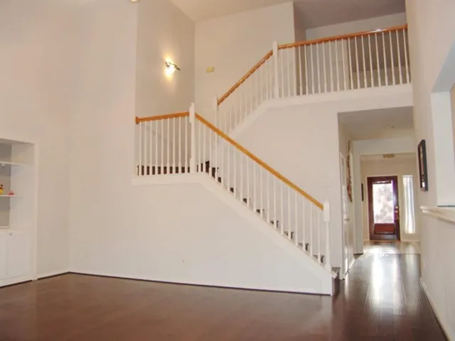 a view of staircase with white walls and a window