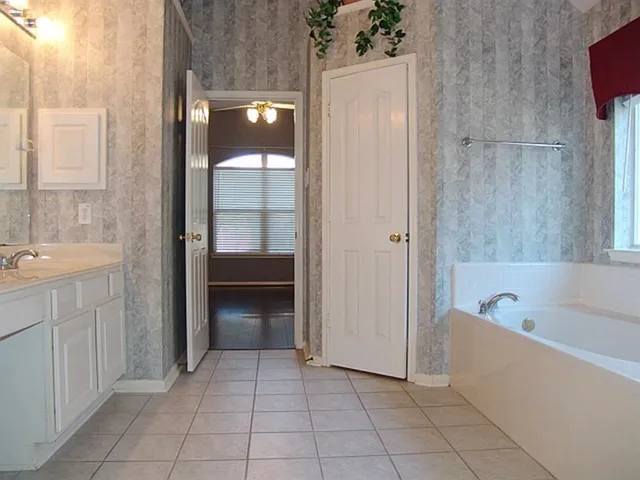 a bathroom with a tub shower and sink