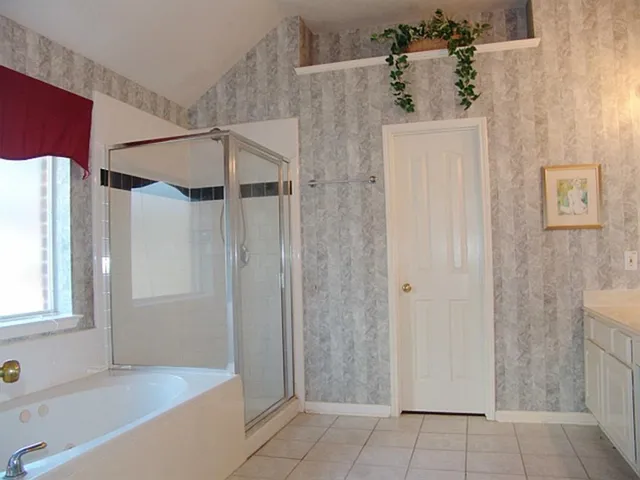 a bathroom with a shower and a tub