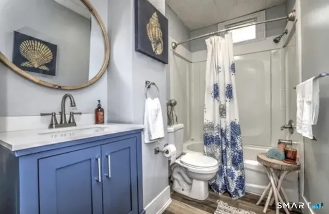 a bathroom with a toilet a sink and a mirror