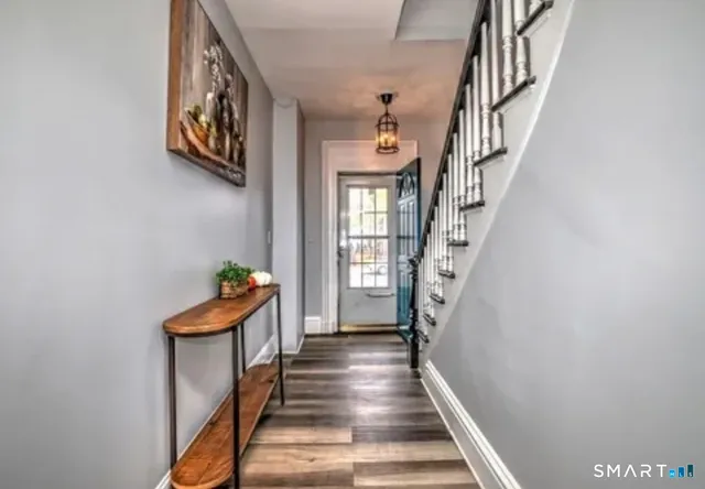 a view of entryway and hall with wooden floor