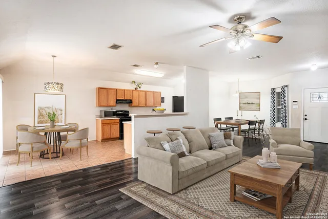 a living room with furniture and kitchen view