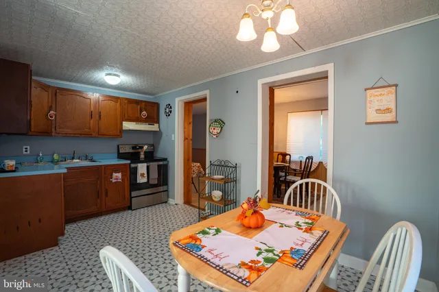 a kitchen with a refrigerator and a stove top oven