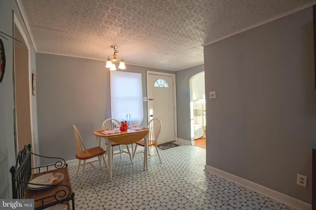 a dining room with furniture and chandelier