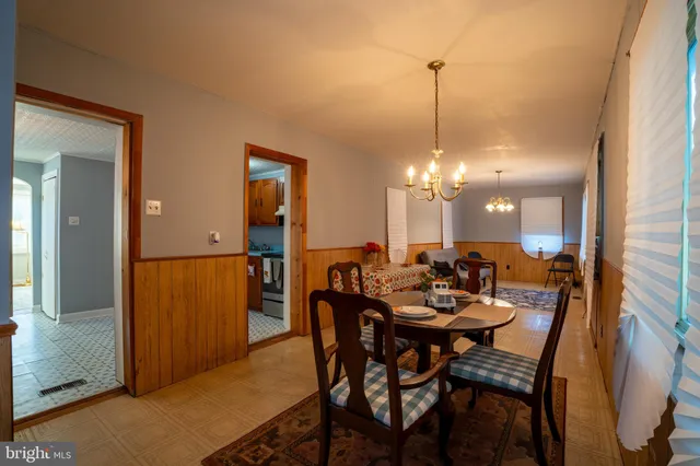 a dining room with furniture and window