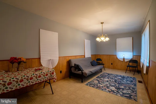 a bedroom with furniture and a chandelier