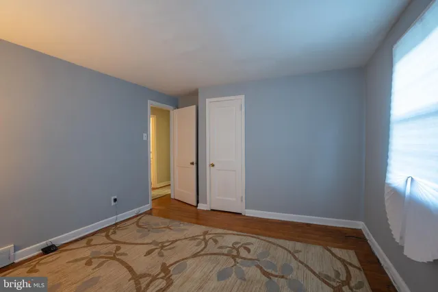a view of room with window and wooden floor
