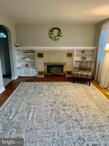 en empty room with fireplace and windows