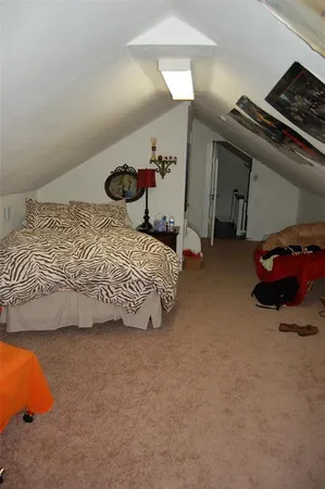 a bedroom with a bed and a couch