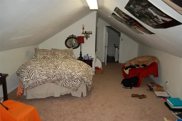 a bedroom with bed and a chandelier