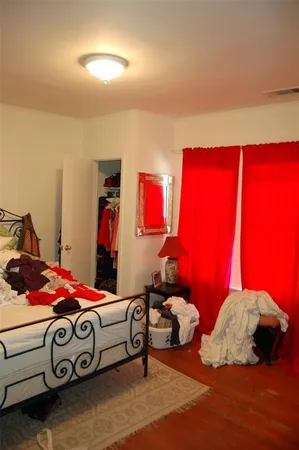 a bedroom with bed and a window