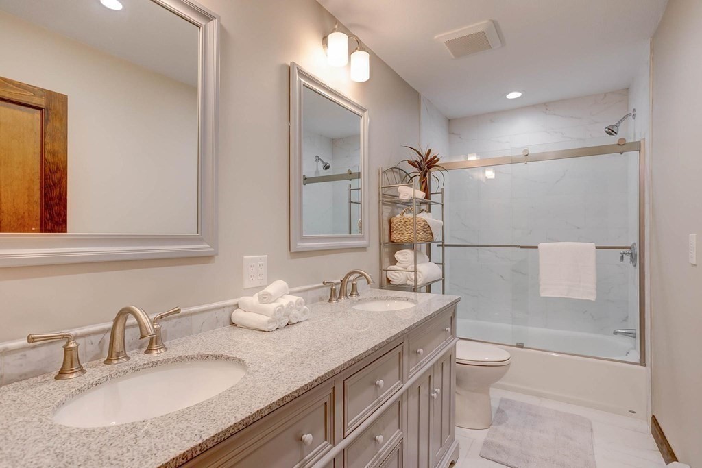 36 Rainbow Circle Peabody, MA 01960 - Photo 15 of 41 a bathroom with a granite countertop sink a toilet and a mirror