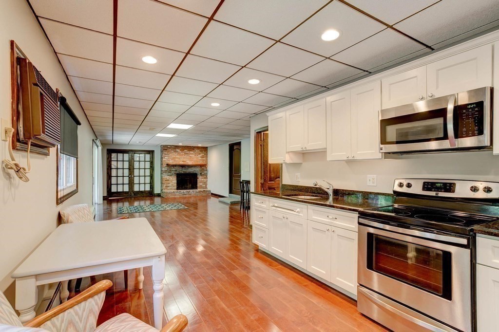 36 Rainbow Circle Peabody, MA 01960 - Photo 19 of 41 a kitchen with stainless steel appliances granite countertop a stove sink microwave and cabinets