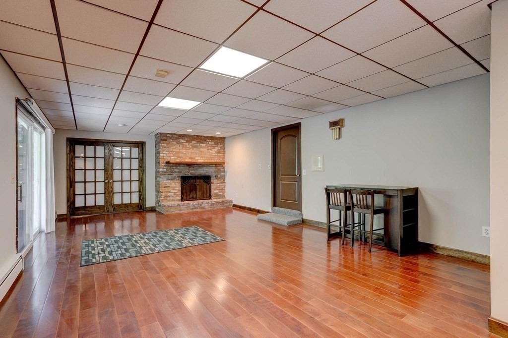 36 Rainbow Circle Peabody, MA 01960 - Photo 20 of 41 a view of empty room with wooden floor and fireplace