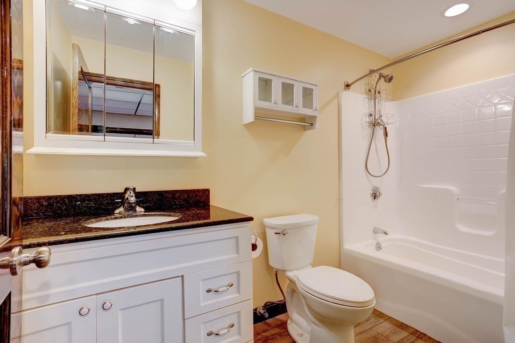 36 Rainbow Circle Peabody, MA 01960 - Photo 23 of 41 a bathroom with a granite countertop sink a toilet and shower