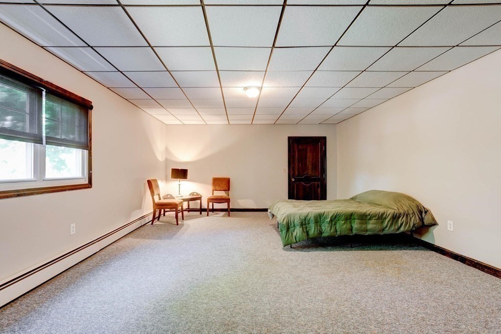 36 Rainbow Circle Peabody, MA 01960 - Photo 24 of 41 a living room with furniture and a chandelier