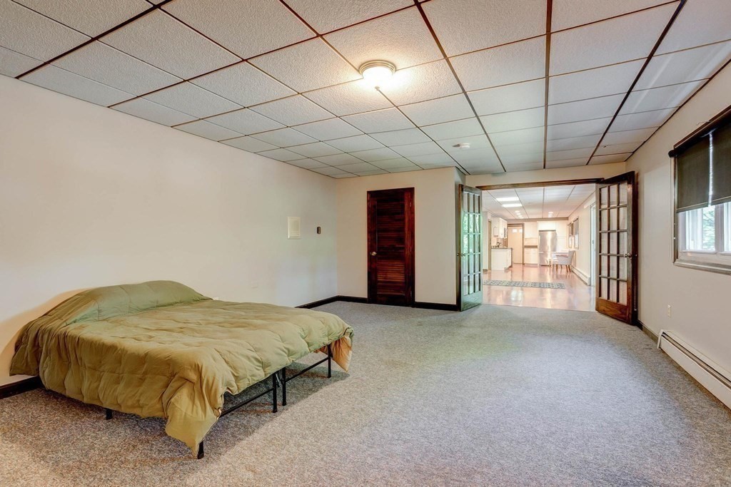 36 Rainbow Circle Peabody, MA 01960 - Photo 25 of 41 a spacious bedroom with a bed and a large window