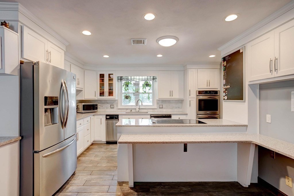 36 Rainbow Circle Peabody, MA 01960 - Photo 3 of 41 a kitchen with stainless steel appliances a refrigerator stove microwave and cabinets