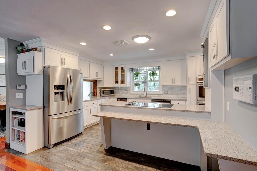 36 Rainbow Circle Peabody, MA 01960 - Photo 4 of 41 a kitchen with stainless steel appliances a refrigerator and a stove