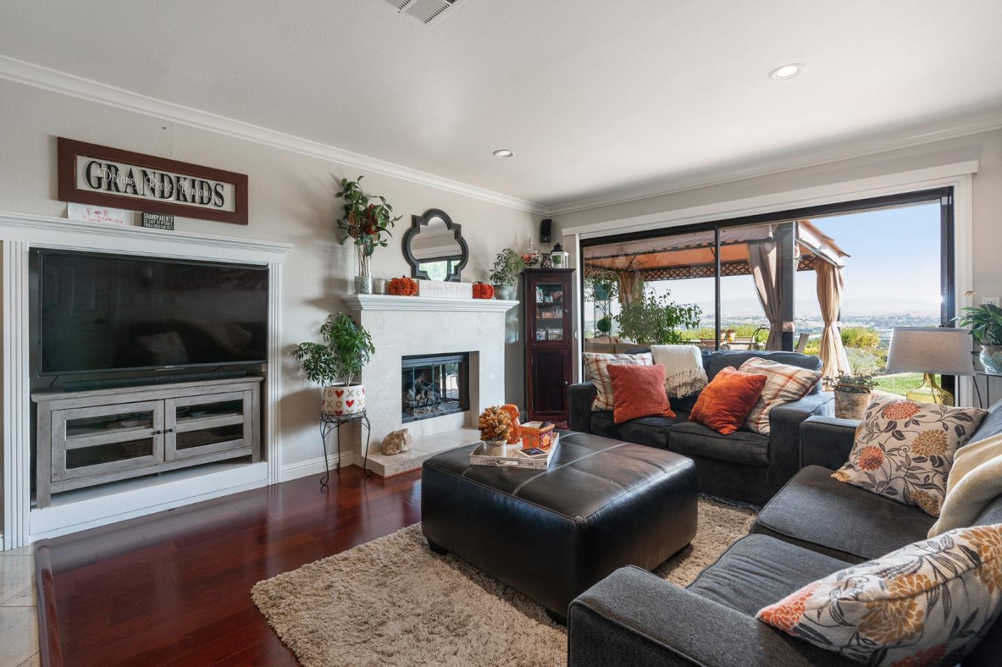 42 Seneca Lane San Ramon, CA 94583 - Photo 9 of 40 a living room with furniture a flat screen tv and a fireplace