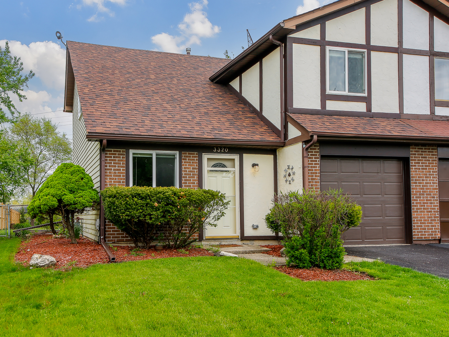 3320 Fox Hill Road Aurora, IL 60504 - Photo 1 of 10 a front view of a house with a garden and plants