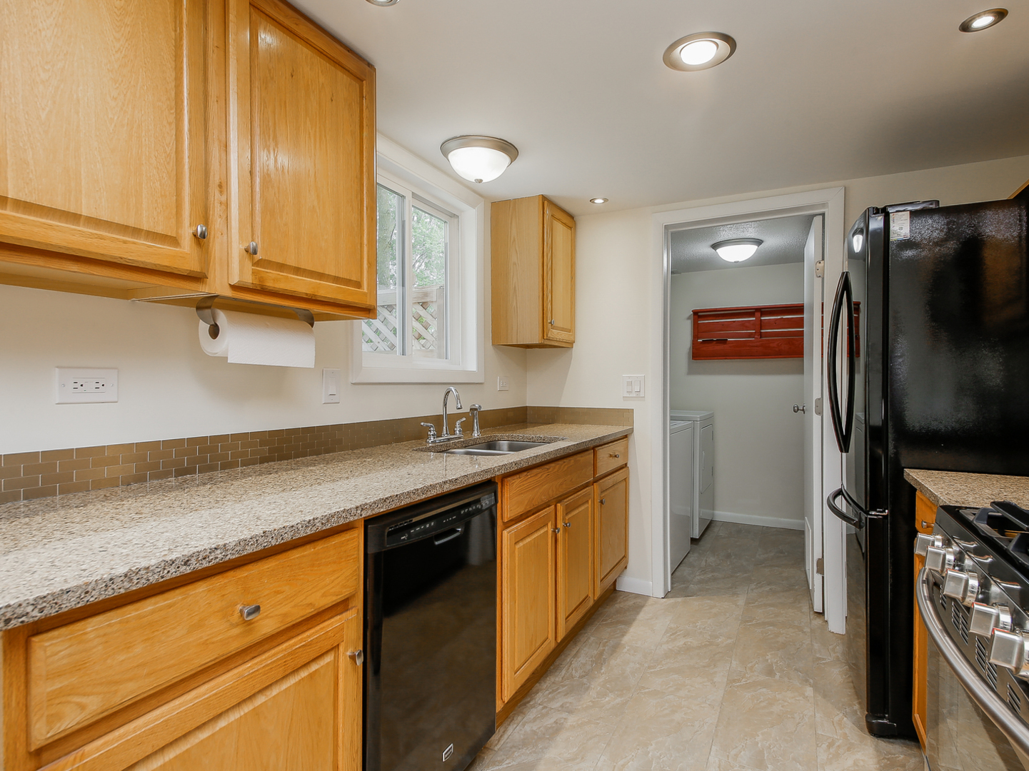 3320 Fox Hill Road Aurora, IL 60504 - Photo 3 of 10 a kitchen with stainless steel appliances granite countertop a sink stove and refrigerator