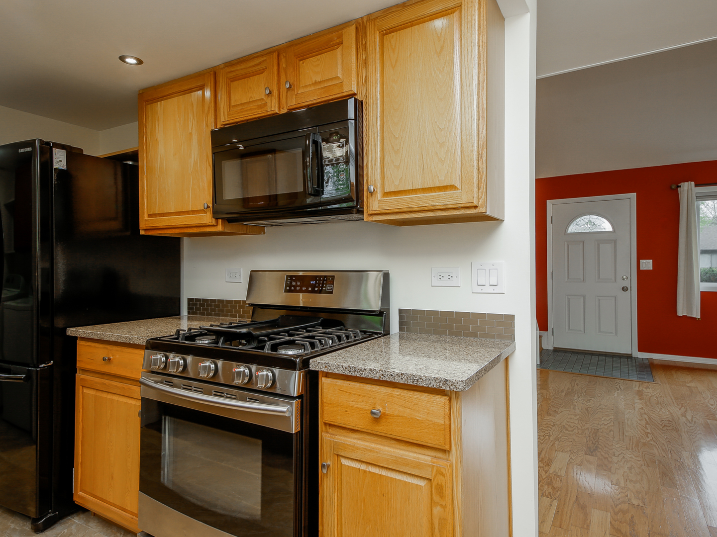 3320 Fox Hill Road Aurora, IL 60504 - Photo 4 of 10 a kitchen with stainless steel appliances granite countertop a stove a microwave and a refrigerator