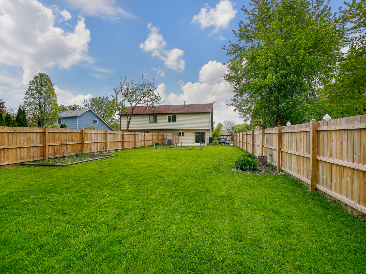 3320 Fox Hill Road Aurora, IL 60504 - Photo 10 of 10 a view of a house with a big yard and large trees