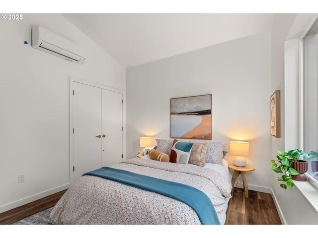 a bedroom with a bed and a lamp