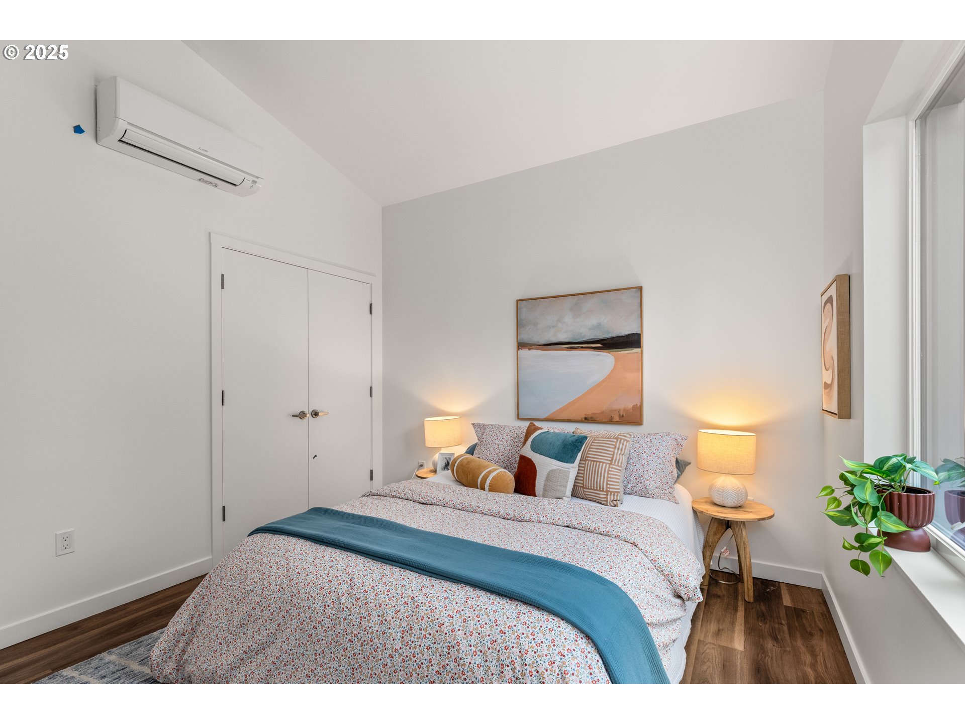 9947 Southeast Cottage Lane, Unit 3 Milwaukie, OR 97222 - Photo 11 of 38 a bedroom with a bed and a lamp