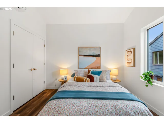 a bedroom with a bed and a potted plant