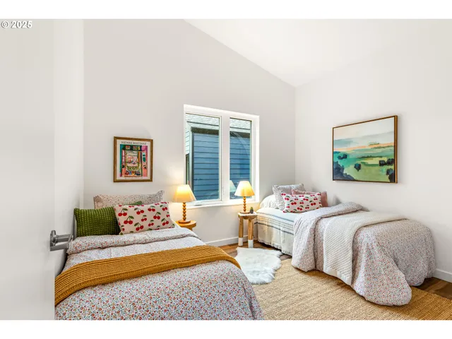 a bedroom with a bed and a painting on the wall