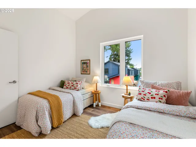 a bedroom with a bed and a large window