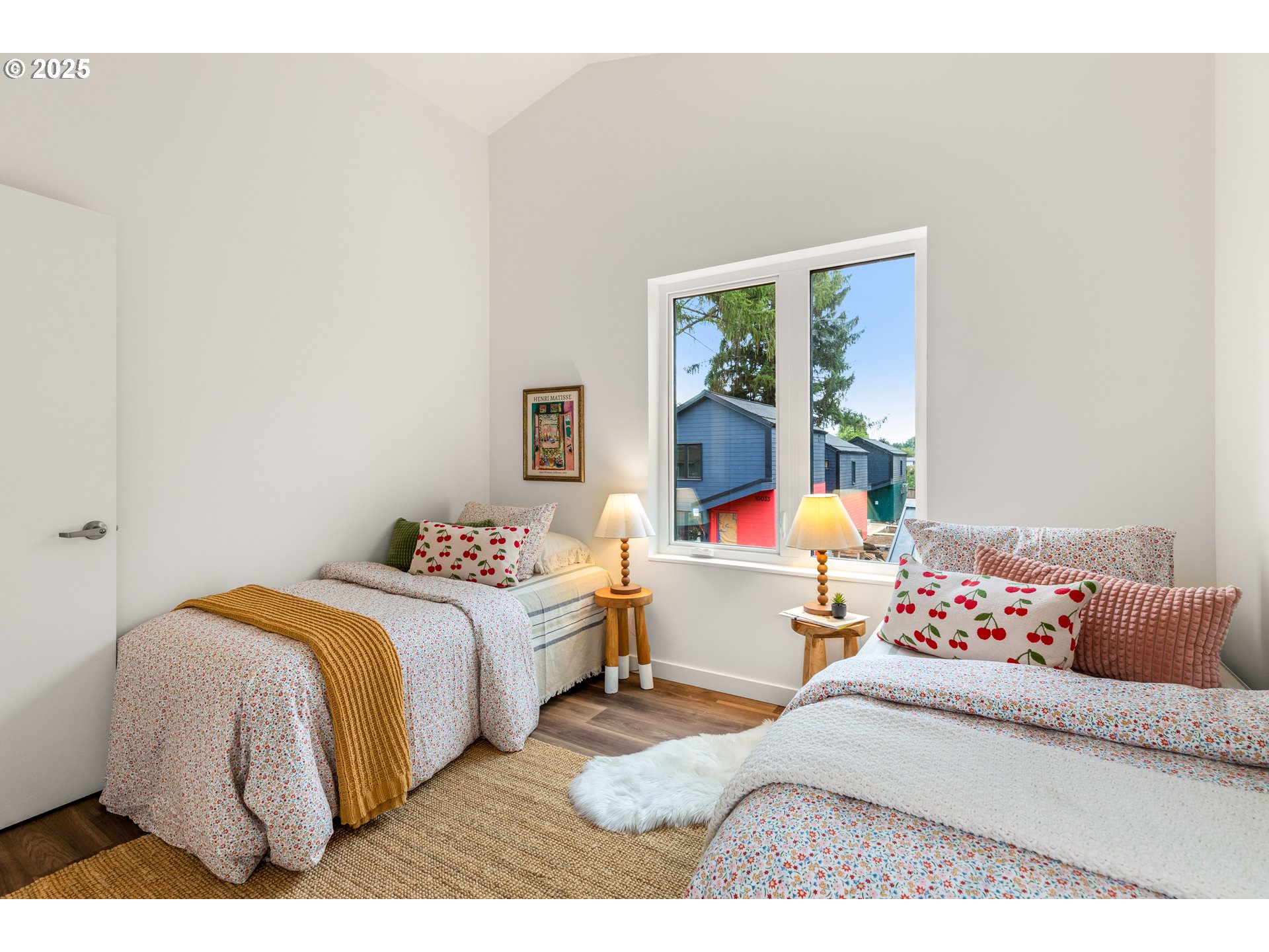 9947 Southeast Cottage Lane, Unit 3 Milwaukie, OR 97222 - Photo 15 of 38 a bedroom with a bed and a large window