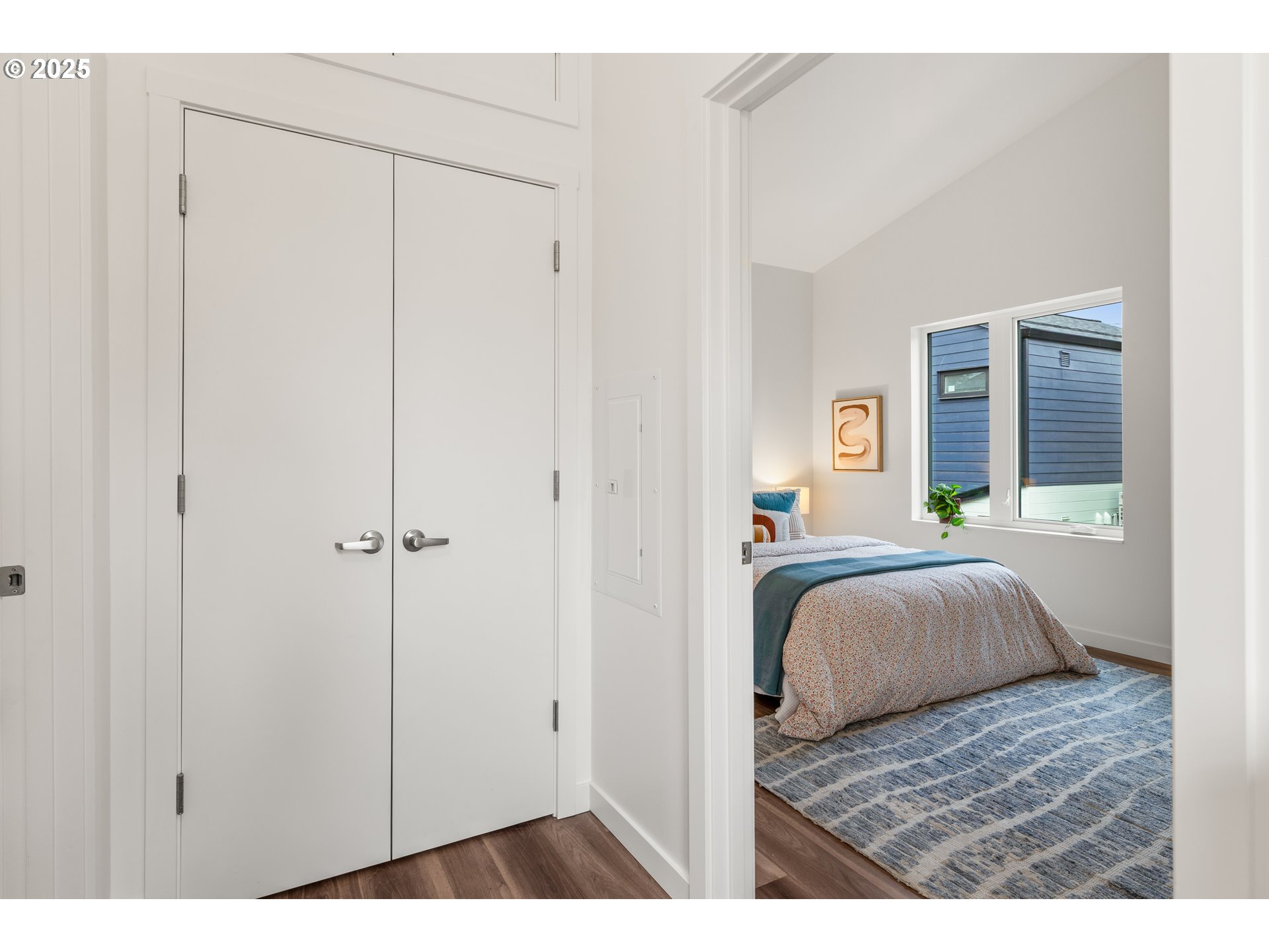 9947 Southeast Cottage Lane, Unit 3 Milwaukie, OR 97222 - Photo 7 of 38 a bedroom with a bed and a window