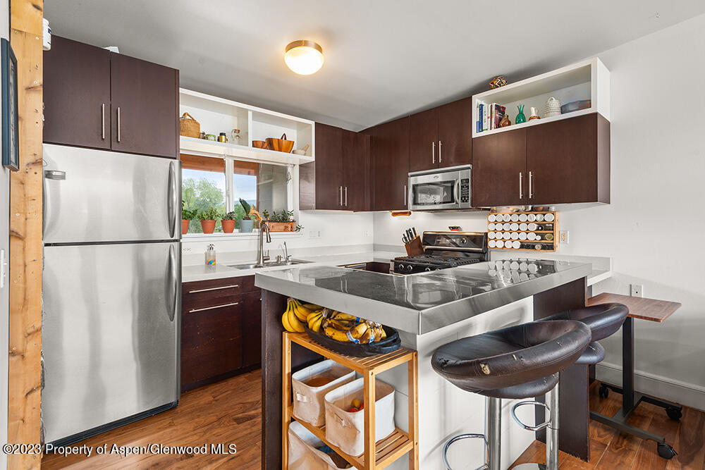 2563 Dolores Way Carbondale, CO 81623 - Photo 5 of 12 a kitchen with stainless steel appliances granite countertop a refrigerator and a stove top oven