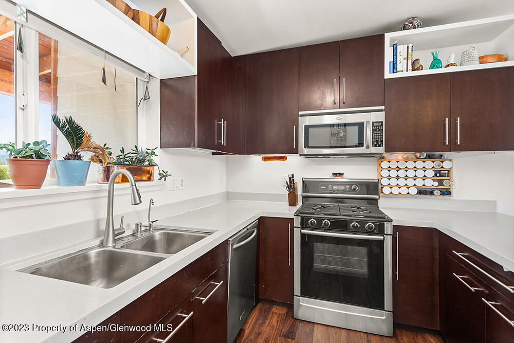 2563 Dolores Way Carbondale, CO 81623 - Photo 6 of 12 a kitchen with granite countertop a sink cabinets and stainless steel appliances