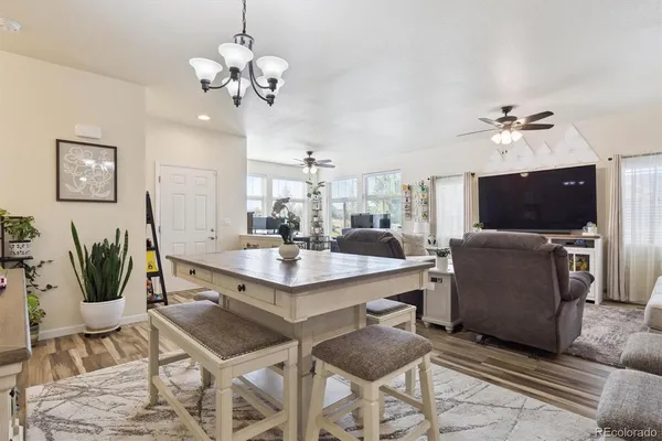 a view of a dining room with furniture and a flat screen tv