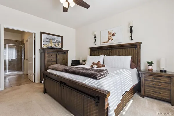 a bedroom with a bed and a tv on the dresser