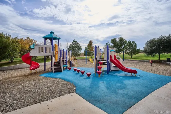 a view of outdoor space with playground and green space
