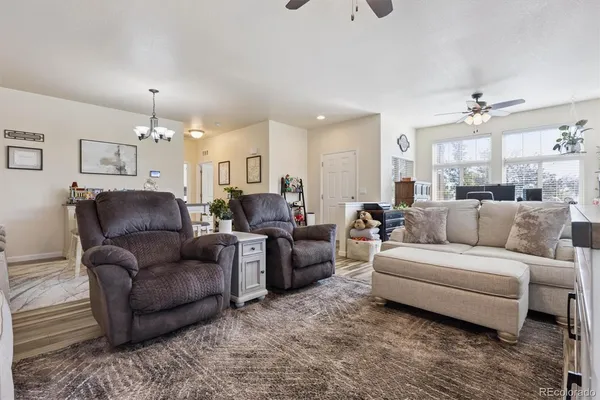 a living room with furniture and a chandelier