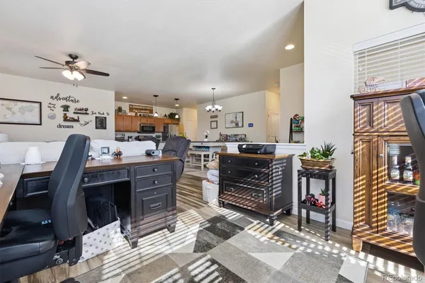 a living room with lots of furniture and kitchen view