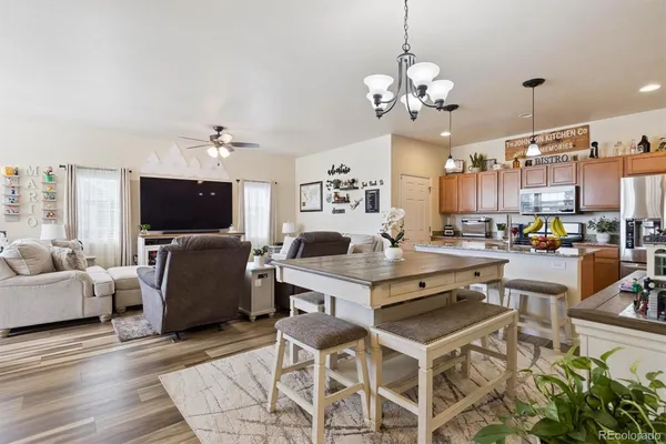 a living room with furniture a chandelier and a flat screen tv
