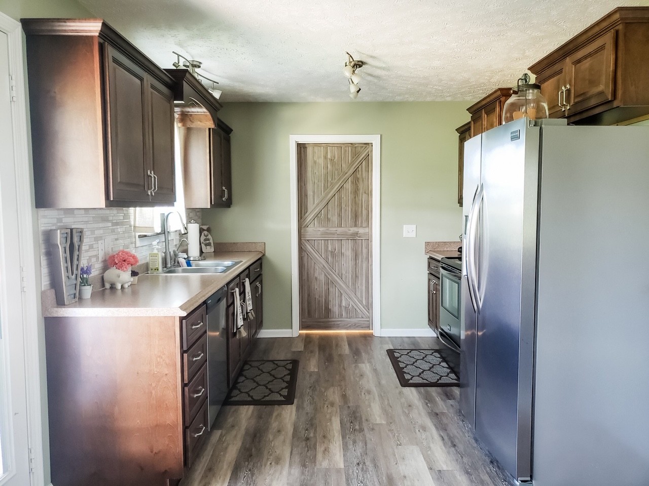 5771 Payne Road Portland, TN 37148 - Photo 6 of 11 a kitchen with a refrigerator a sink and wooden floor