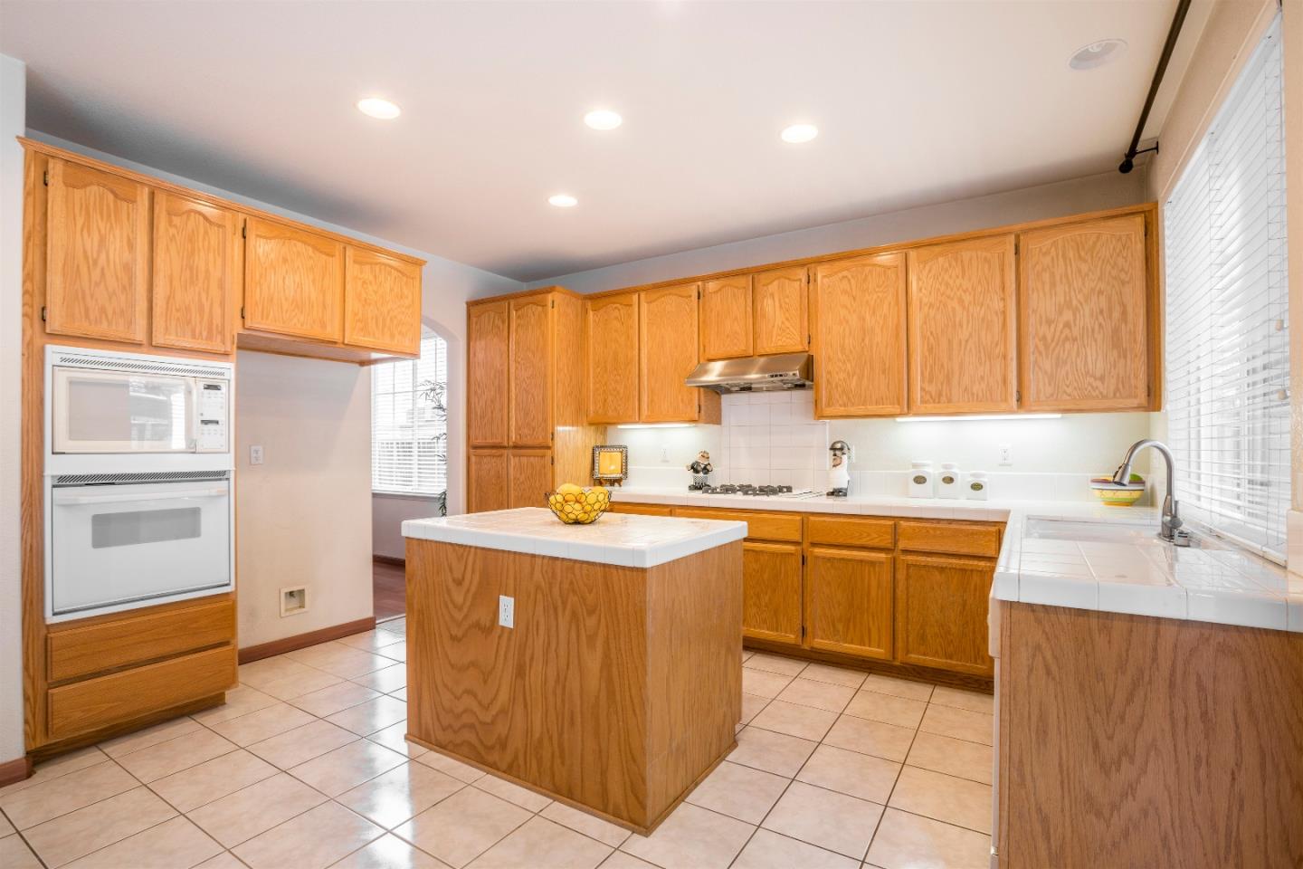 2235 Woodranch Road San Jose, CA 95131 - Photo 14 of 40 a kitchen with stainless steel appliances granite countertop a sink and cabinets